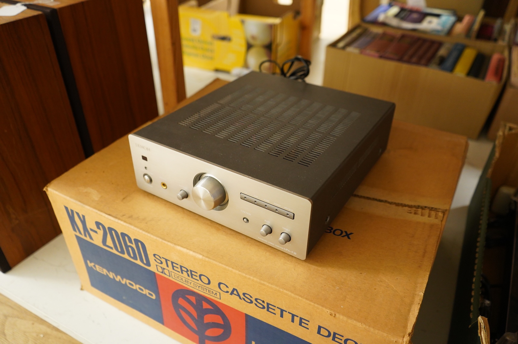 A collection of stereo equipment, including a Project P1 turntable record player, a Denon UPA-F10 integrated stereo amplifier with remote control, a boxed Kenwood KX-260 cassette tape player and a pair of Monitor Audio s